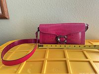 Front view showing flap, C turn-lock, full length on measuring tape