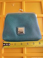 Front view showing logo plate, leather texture and width measurement