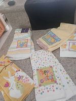 Group shot of all five Easter-themed towels spread out on carpet