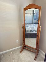 Front view of full-length cheval mirror showing frame, glass and base
