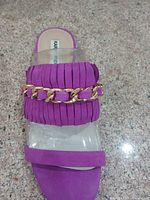 Top view of sandal showing purple pleated strap with gold chain and clear strap