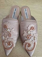 Top view of both rose gold satin Karl Lagerfeld mules showing embroidery, bead and faux pearl embellishments, size US 7.5