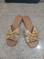 Full view of both sandals showing braided straw uppers and rhinestone embellishments