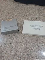 Grey and white outer boxes showing product names and weight