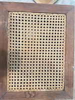 Top view showing rectangular cane woven insert and wood border