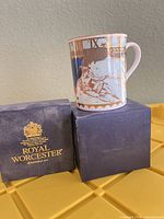 Mug on two Royal Worcester boxes