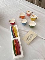 All four teacups and foam-packed saucers with Junk Gypsy card visible