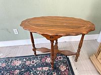 Full view of solid wood accent table showing top, legs and stretcher
