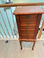 Full front view showing entire armoire, drawers, legs, hardware