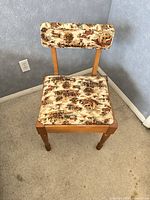 front view of chair showing upholstery pattern and wooden frame
