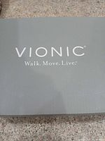 Grey Vionic shoe box lid with brand logo