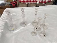 Group shot of seven Waterford crystal candlesticks on table