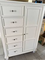 Front view showing drawers and cabinet door