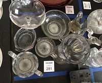 Top view of assorted clear pressed glass pieces