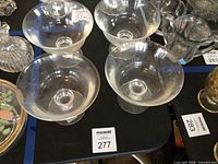 Four Ralph Lauren crystal dessert bowls on table