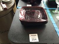 Stack of six square ruby red glass plates