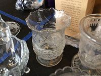 close view of scalloped-rim tumbler and other pieces