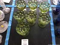 Seven green stem glasses displayed top view showing bubble pattern inside bowls