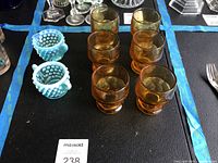 Lot overview showing six amber juice glasses and two blue opalescent hobnail pieces