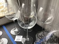 Four Lenox etched balloon wine glasses showing bowls, stems and etched band pattern