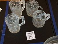 Top view of four Batman Forever mugs showing character reliefs