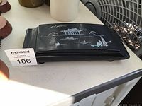 Top view of closed black lacquer incense box with mother of pearl landscape inlay