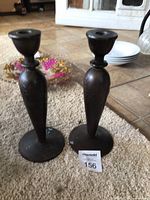 Front view of both bronze candlesticks on carpet