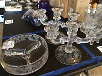 Clear glass ivy etched candleholders and divided candy bowl on table