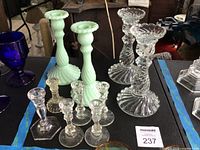 Group showing all candlesticks: two jadeite swirl, two clear swirl, six miniature