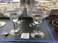 Four Crate & Barrel millefiori stem margarita glasses on table