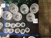 Top view of six brandy snifters and nine shot glasses