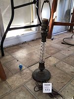 Full view of lamp showing crystal column, brass base, socket and cord