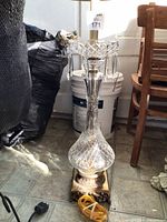 Full view of lamp showing crystal body, prisms, metal base, power cord