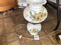 Full view of lamp showing both floral glass globes and electric cord