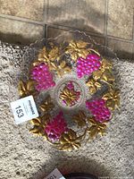 Top view of Goofus Glass plate showing painted grapes and gold leaves