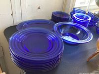 Stacked round plates and bowl showing cobalt color and ring design