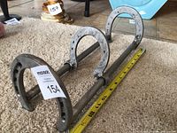 Overall view of horseshoe cookbook holder with measuring tape for scale