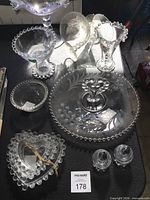 Group shot showing majority of Candlewick pieces including torte plate, heart dish, bowls and shakers