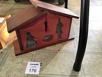 Closed wood stable case with lot tag visible