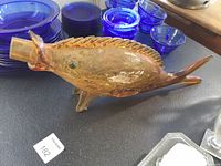 Side view showing overall shape, amber crackle glass, green eye, dorsal fin