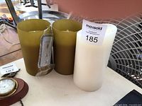 Front view of three candles with remote attached to two green candles