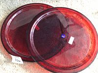 Two red glass platters side by side