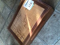 Closed wooden box showing figured lid panel and overall condition