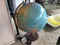 Full view of illuminated Replogle globe on stand