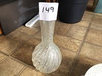 Full view of clear glass vase showing spiral ribbing and bubble inclusions