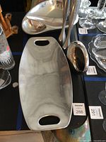 Overall view showing serving tray, ladle, portion of bowl and candlesticks