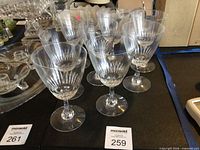 Full set of 8 cut crystal wine glasses on display