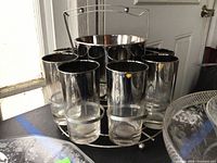 Front view of set showing tumblers, bucket, carrier