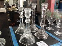 Four Tiffany & Co. crystal candlesticks between blue tape, showing two distinct patterns