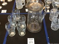 Pitcher with lid and tumblers grouped together